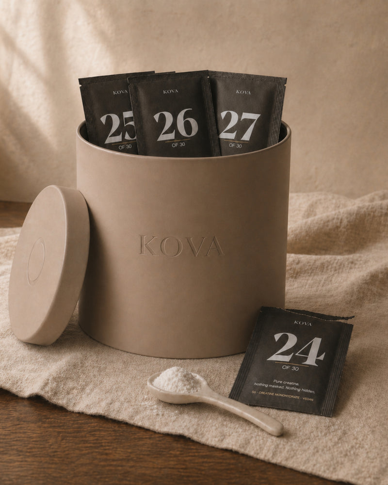 Twenty-four mornings of KOVA — half-empty vessel beside torn-open sachet 24